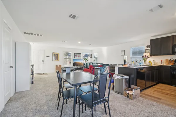 a view of dining room and kitchen with furniture and a view of kitchen