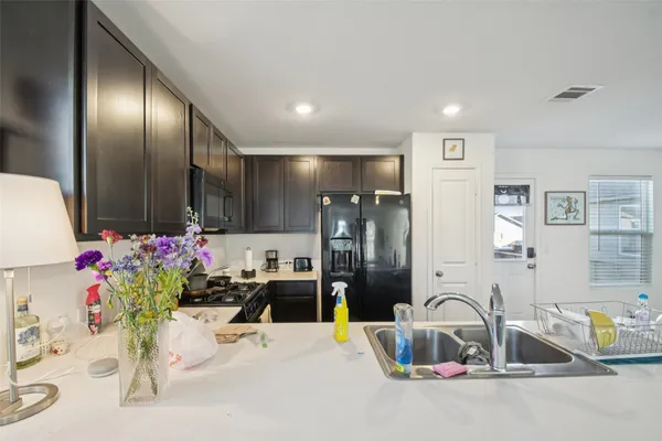 a kitchen with stainless steel appliances granite countertop a refrigerator and a stove