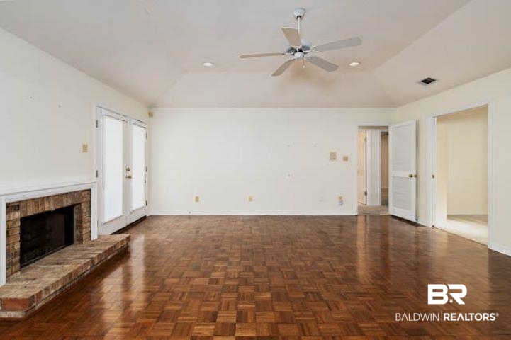 12 Stonebridge Court Mobile, AL 36608 - Photo 6 of 38 Unfurnished living room with a ceiling fan, lofted ceiling, a brick fireplace, and recessed lighting