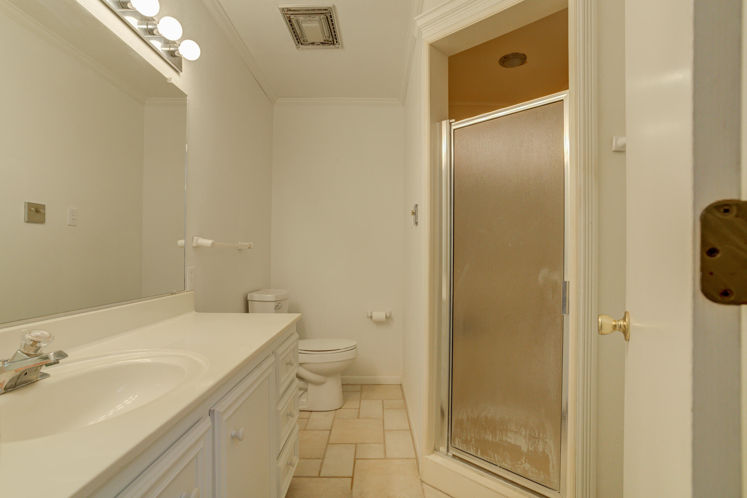 601 18th Street Seagraves, TX 79359 - Photo 13 of 19 a bathroom with a granite countertop sink toilet and shower