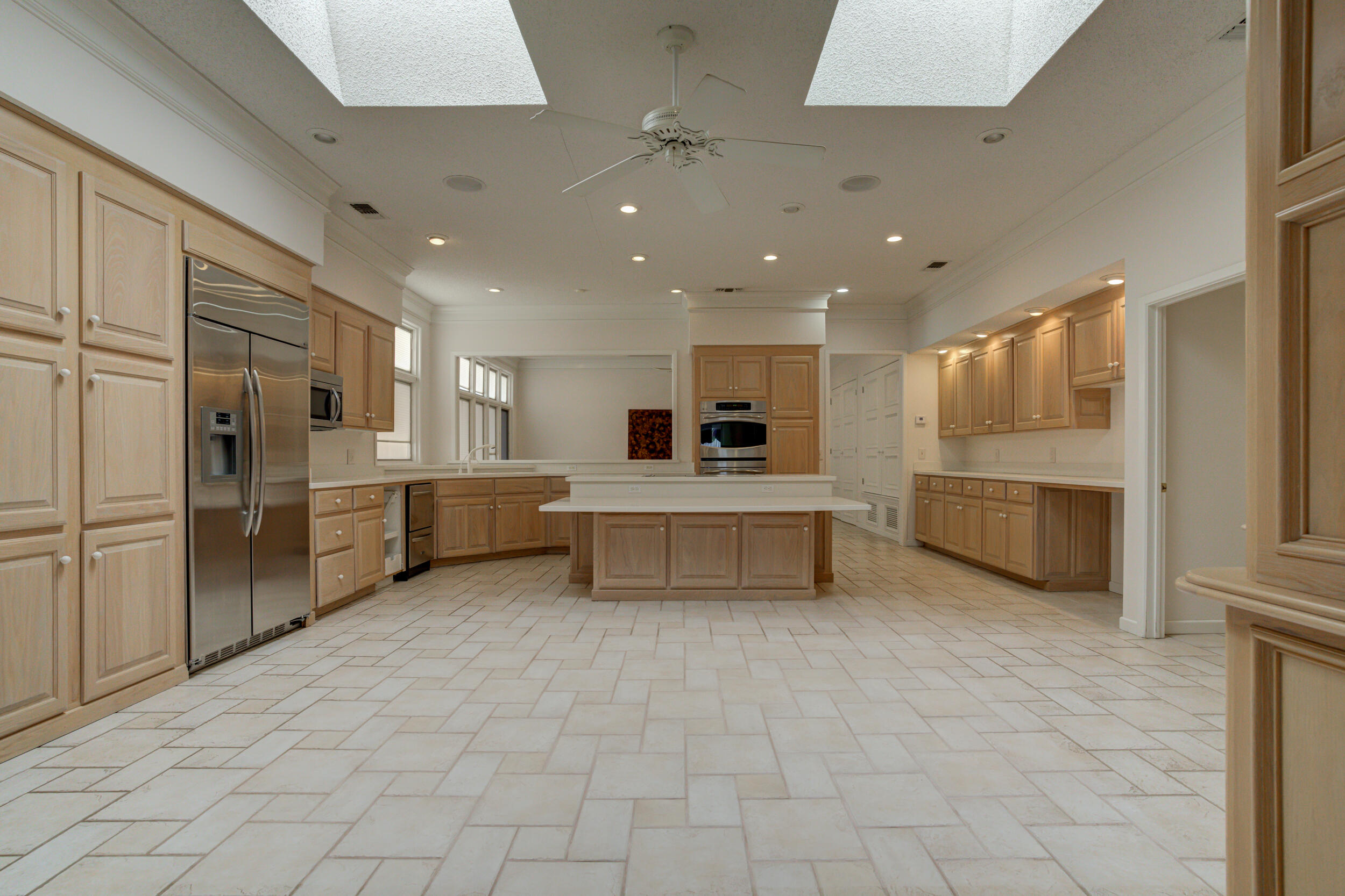 601 18th Street Seagraves, TX 79359 - Photo 3 of 19 a large white kitchen with stainless steel appliances kitchen island granite countertop a refrigerator and a stove top oven