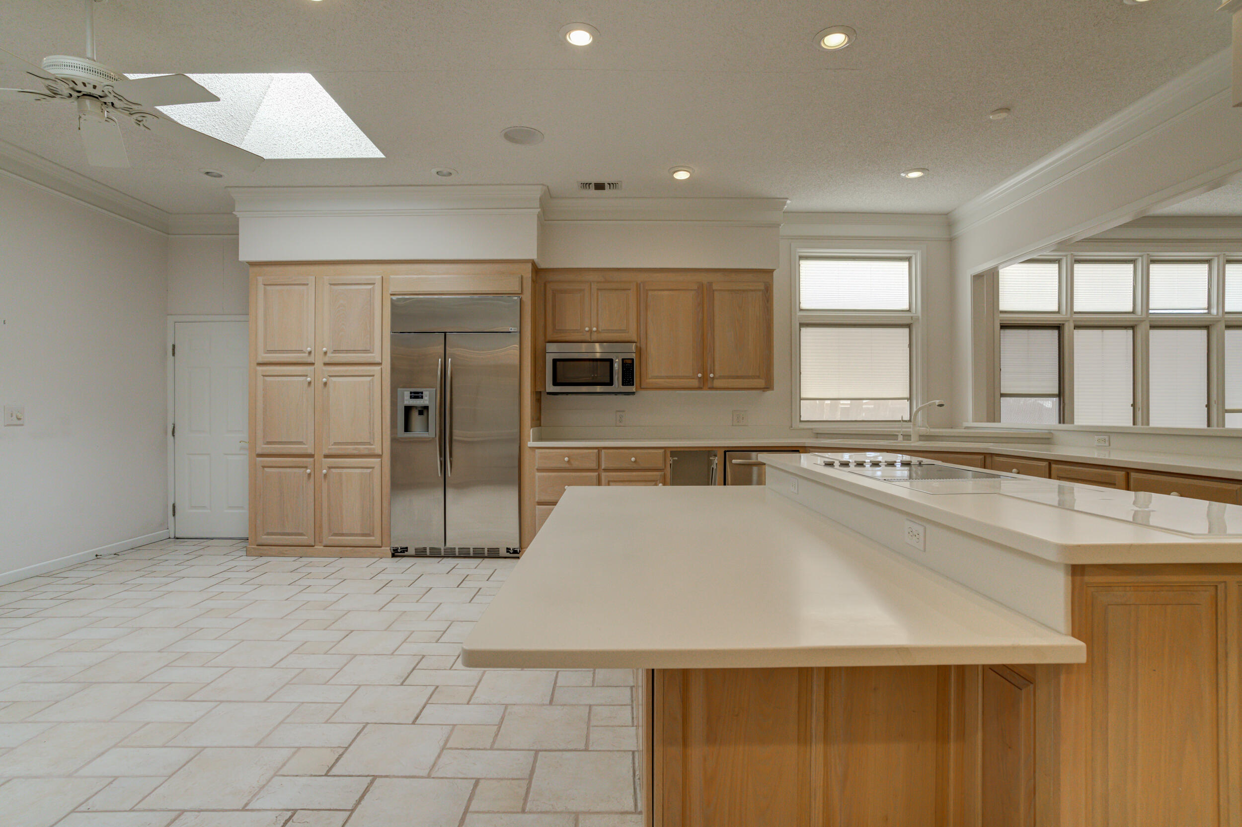 601 18th Street Seagraves, TX 79359 - Photo 5 of 19 a large kitchen with a large counter top a sink stainless steel appliances and cabinets