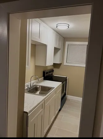 a kitchen with a sink and cabinets
