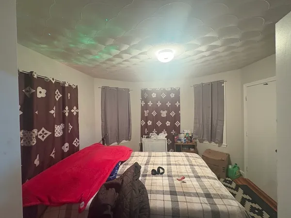 a bedroom with a bed and a window