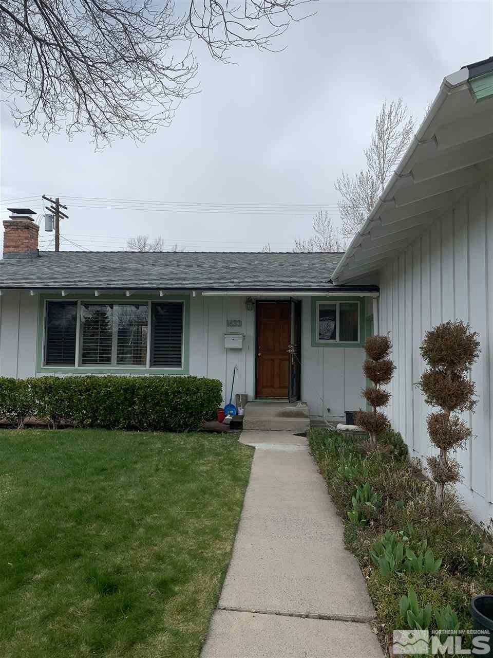 1433 Samuel Way Reno, NV 89509 - Photo 1 of 9 a front view of a house with a yard and garage