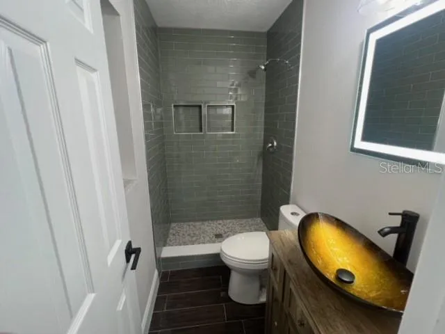 a bathroom with a sink toilet and shower