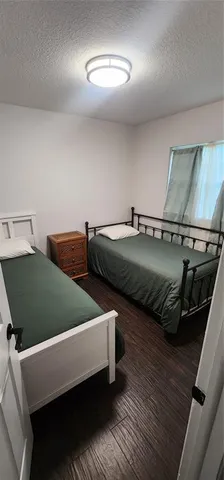 a bed sitting in a bedroom next to a window