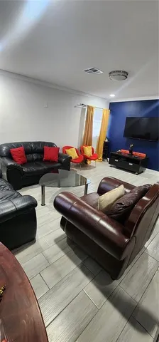 a living room with furniture gym equipment and a rug