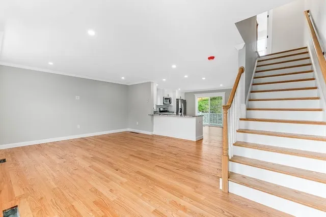 a view of kitchen and hall with wooden floor