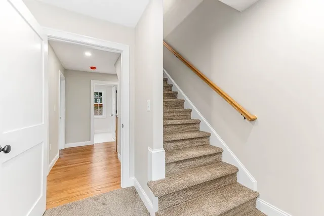 a view of entryway and hall with wooden floor