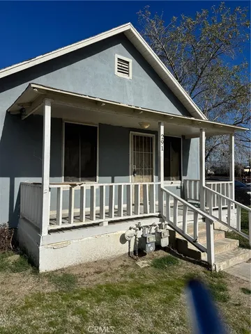 a view of a house with wooden floor and a yard