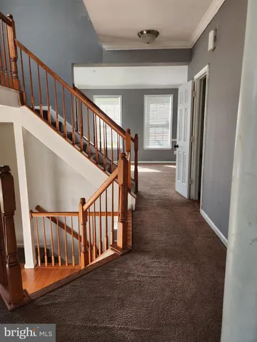 a view of staircase with railing and a window