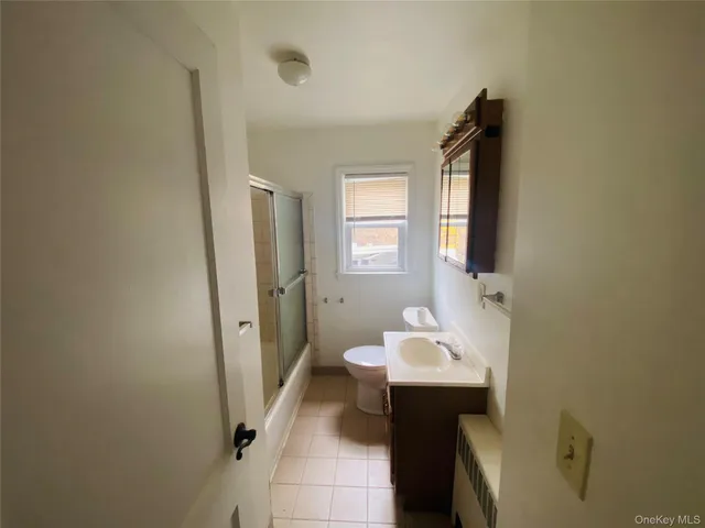 a view of road with parked cars