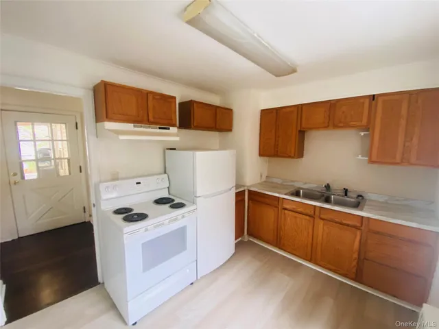 a kitchen with stainless steel appliances a stove microwave and sink