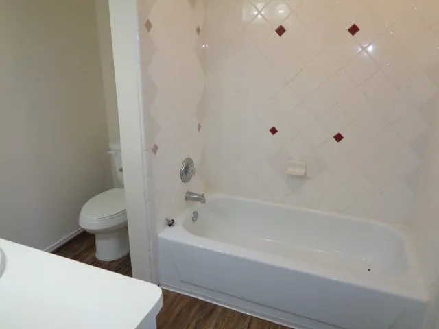a bathroom with a bathtub and toilet