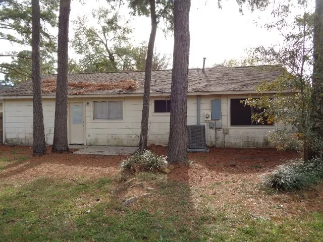 a view of a house with a tree in the background