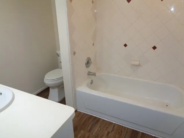 a bathroom with a sink a toilet and bathtub