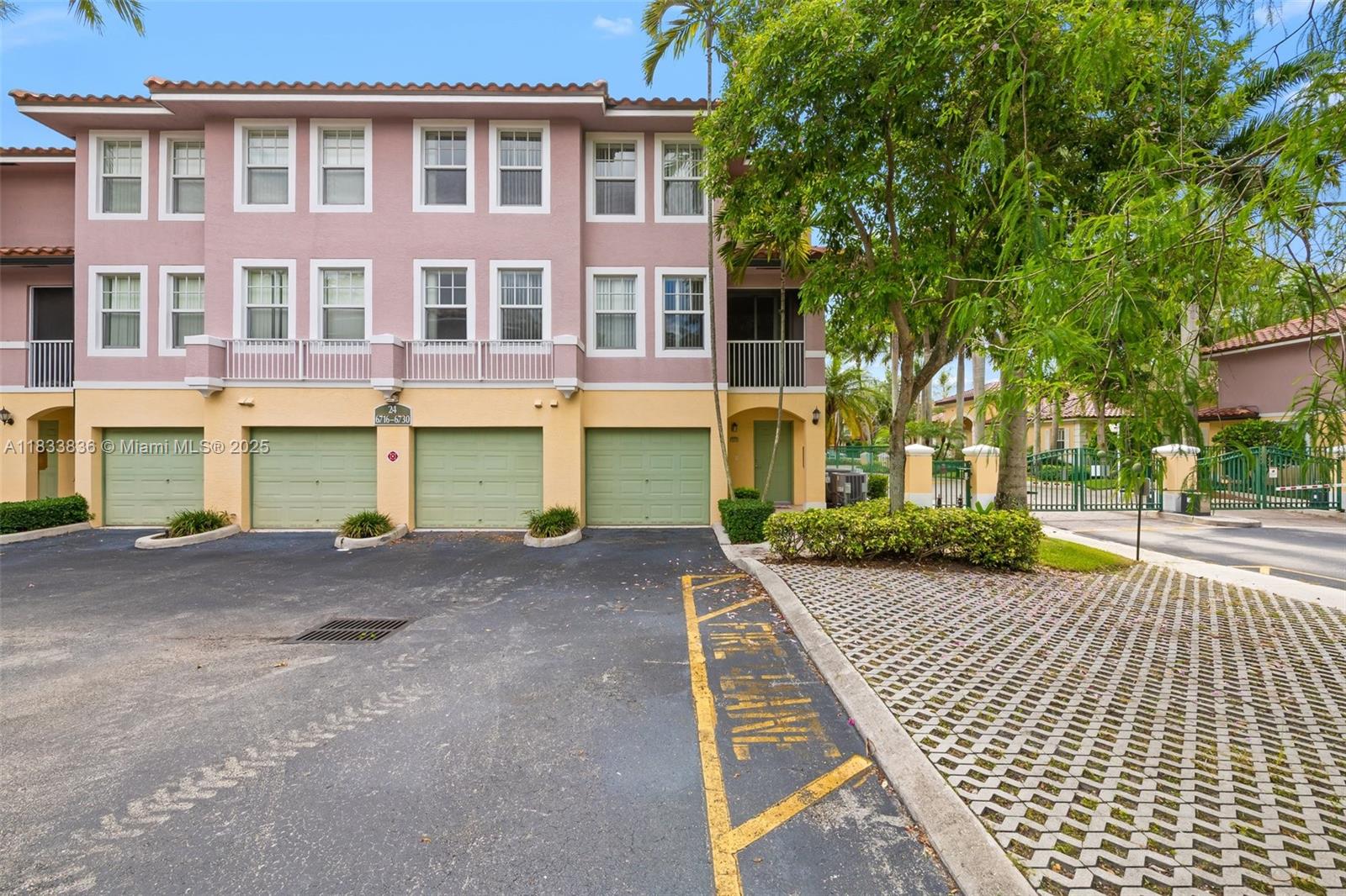 6722 West Sample Road, Unit 6722 Coral Springs, FL 33067 - Photo 1 of 23 a view of a brick house with a yard and large tree