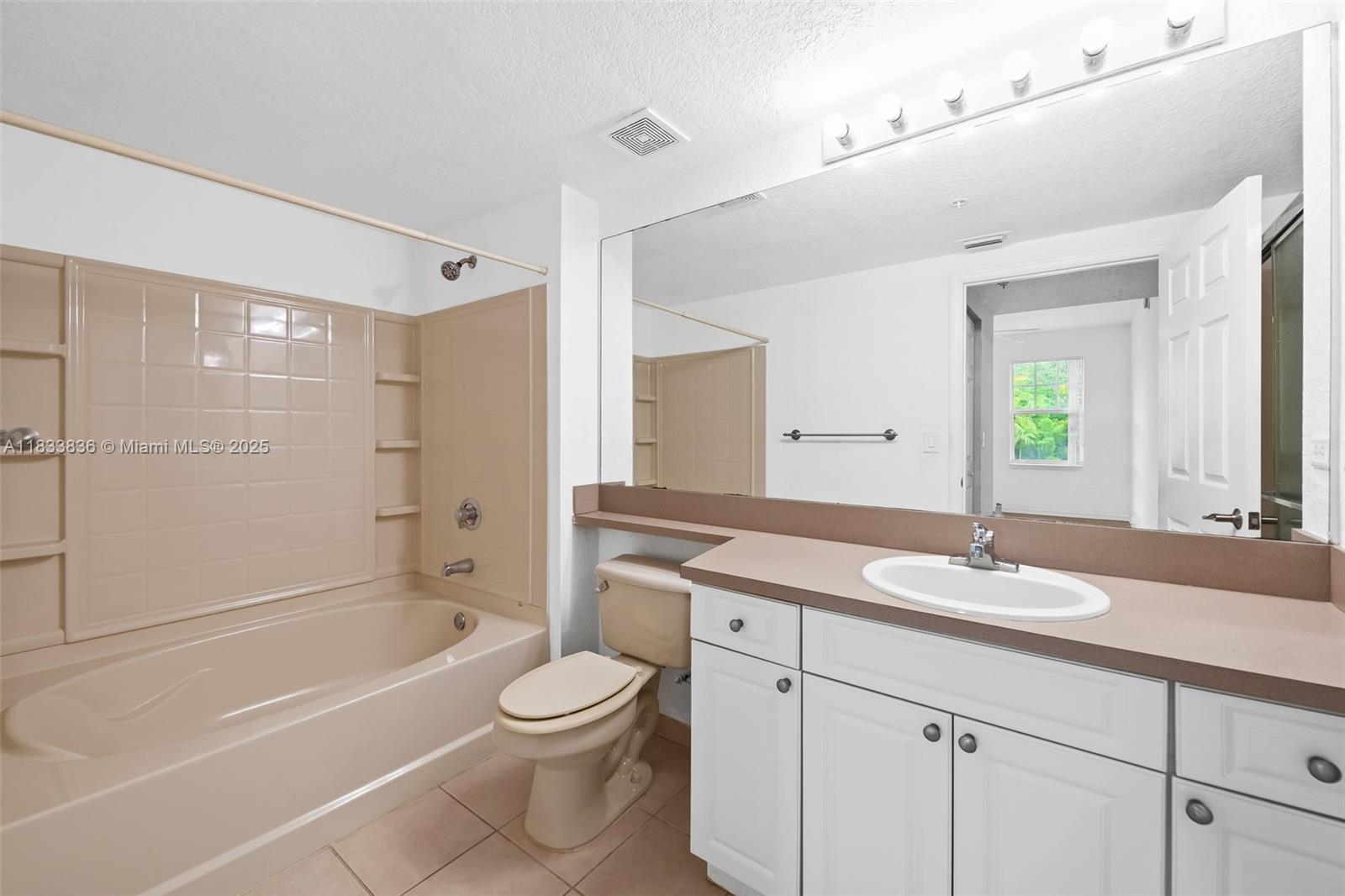 6722 West Sample Road, Unit 6722 Coral Springs, FL 33067 - Photo 16 of 23 a bathroom with a granite countertop sink a toilet and shower