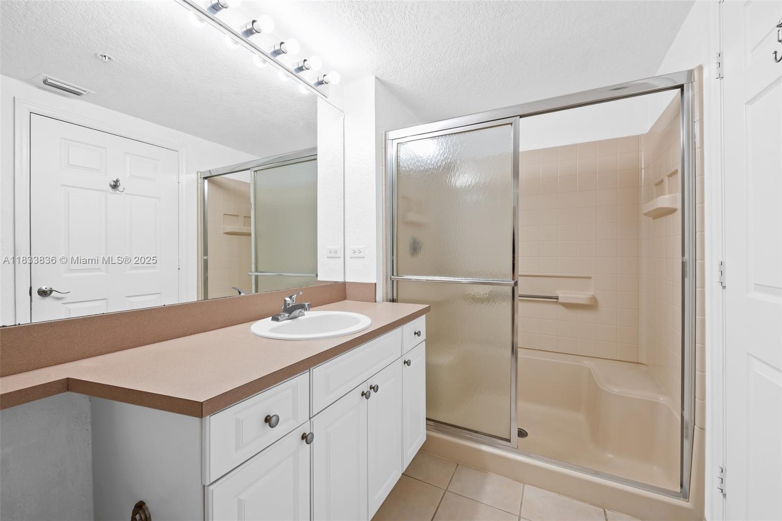 6722 West Sample Road, Unit 6722 Coral Springs, FL 33067 - Photo 17 of 23 a bathroom with a shower sink and mirror