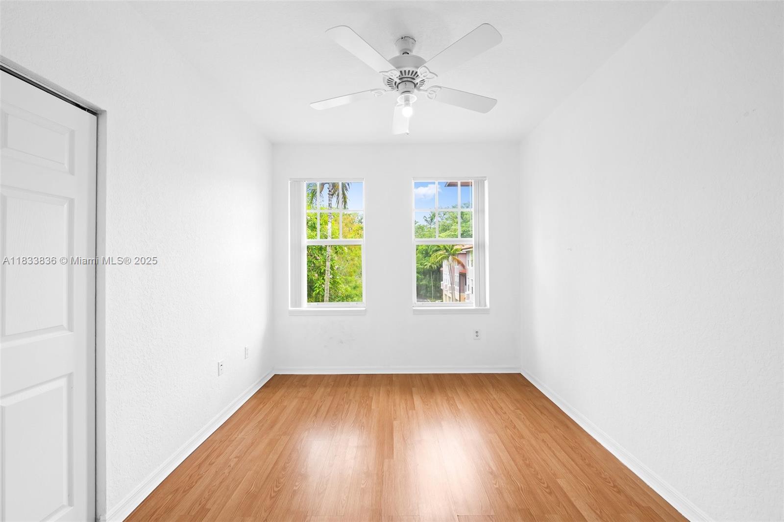 6722 West Sample Road, Unit 6722 Coral Springs, FL 33067 - Photo 18 of 23 an empty room with windows and entrance