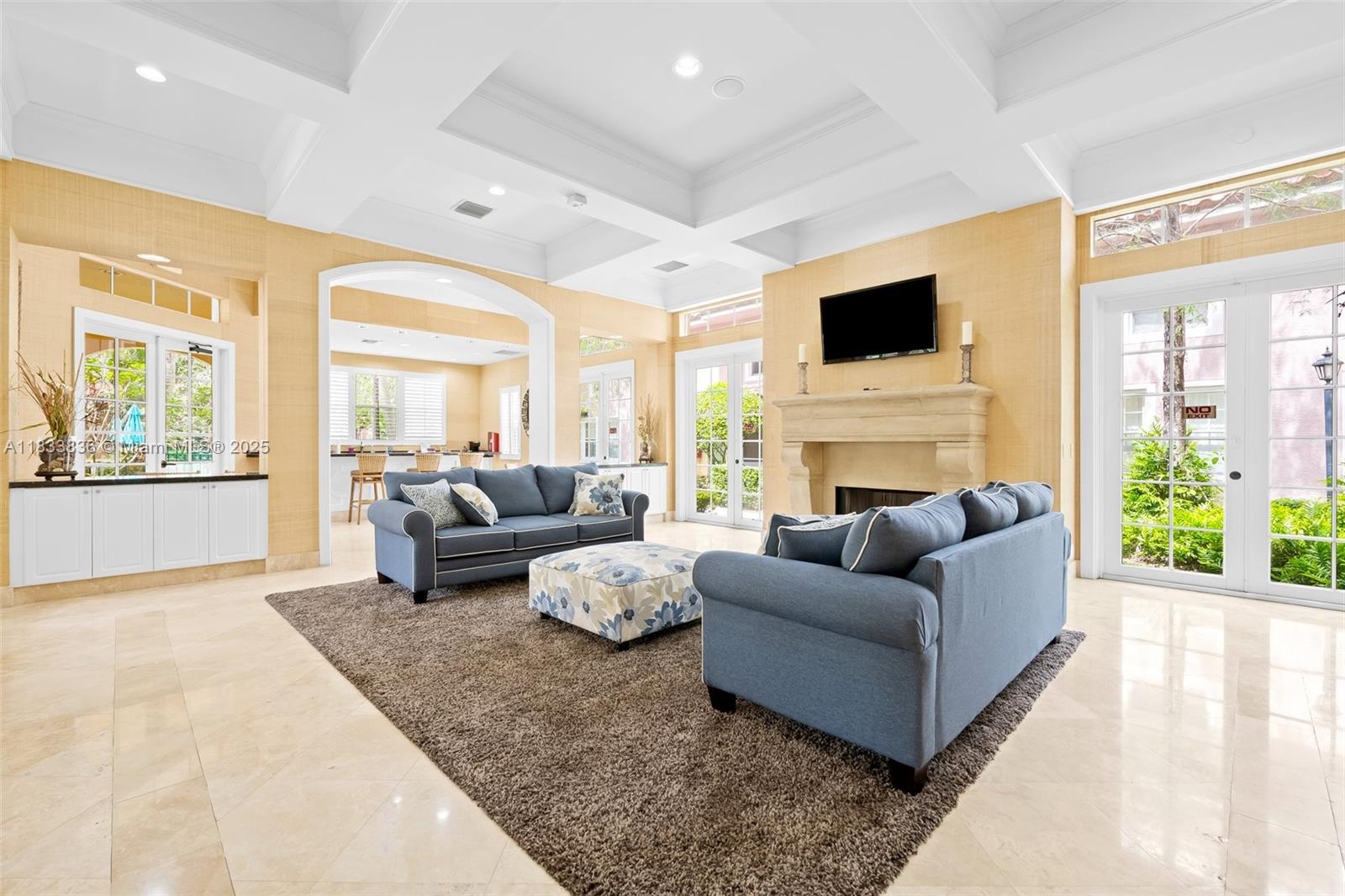 6722 West Sample Road, Unit 6722 Coral Springs, FL 33067 - Photo 23 of 23 a living room with furniture fireplace and flat screen tv