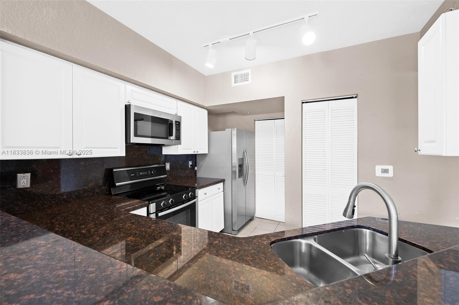 6722 West Sample Road, Unit 6722 Coral Springs, FL 33067 - Photo 10 of 23 a kitchen with a sink cabinets and stainless steel appliances