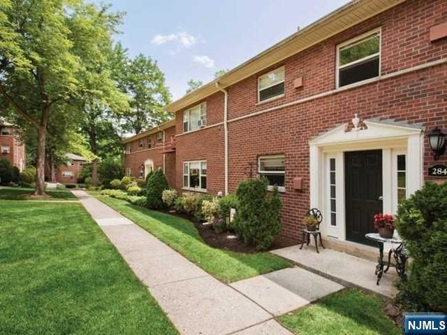 280-320 Oak Street, Unit 304D Ridgewood, NJ 07450 - Photo 21 of 23 a front view of a house with a garden