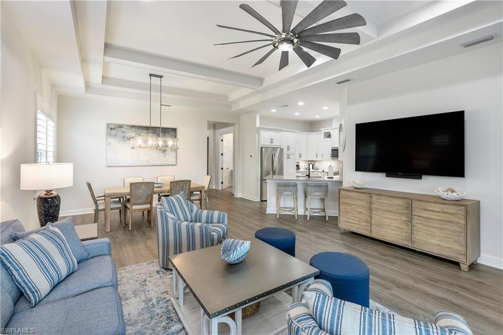 6847 Saona Court Naples, FL 34113 - Photo 1 of 47 a living room with furniture and a flat screen tv