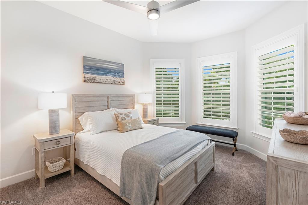6847 Saona Court Naples, FL 34113 - Photo 14 of 47 a bedroom with a bed and a window