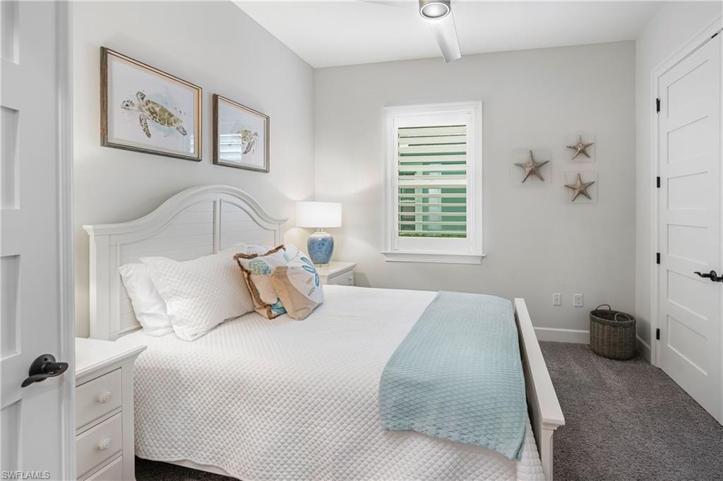 6847 Saona Court Naples, FL 34113 - Photo 16 of 47 a bedroom with a bed and a window