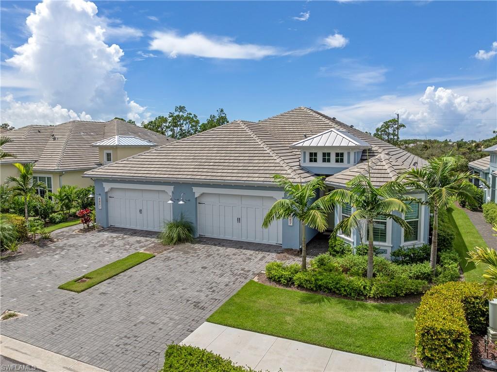 6847 Saona Court Naples, FL 34113 - Photo 21 of 47 a front view of a house with a yard and garage