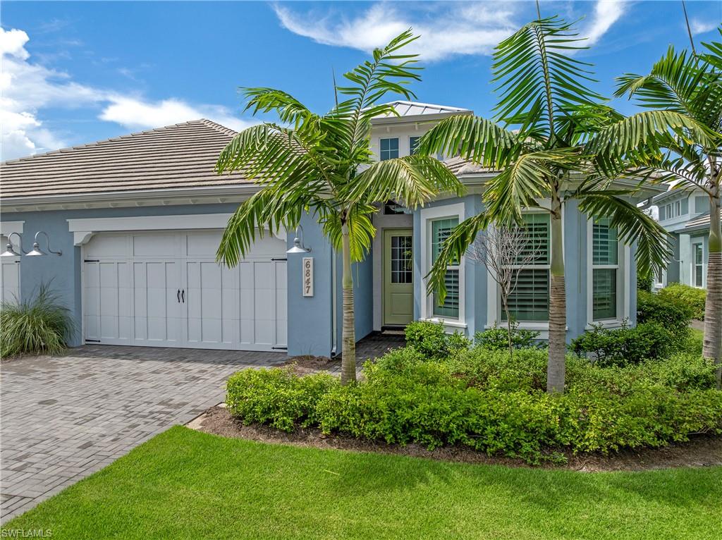 6847 Saona Court Naples, FL 34113 - Photo 22 of 47 a front view of house with yard and green space