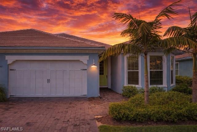 6847 Saona Court Naples, FL 34113 - Photo 27 of 47 front view of a house with a yard