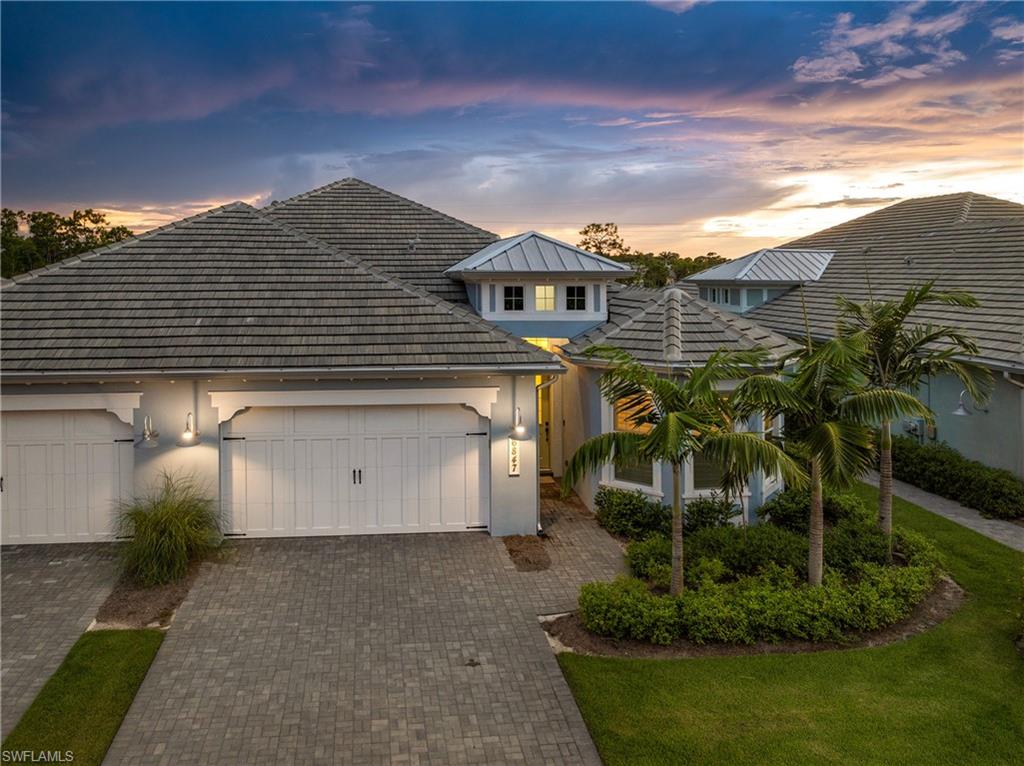 6847 Saona Court Naples, FL 34113 - Photo 29 of 47 a front view of a house with a yard and garage