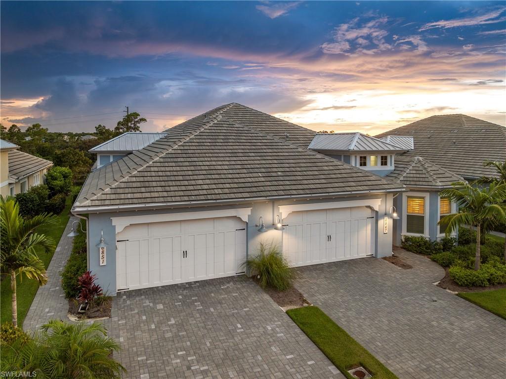 6847 Saona Court Naples, FL 34113 - Photo 30 of 47 a front view of a house with a garage