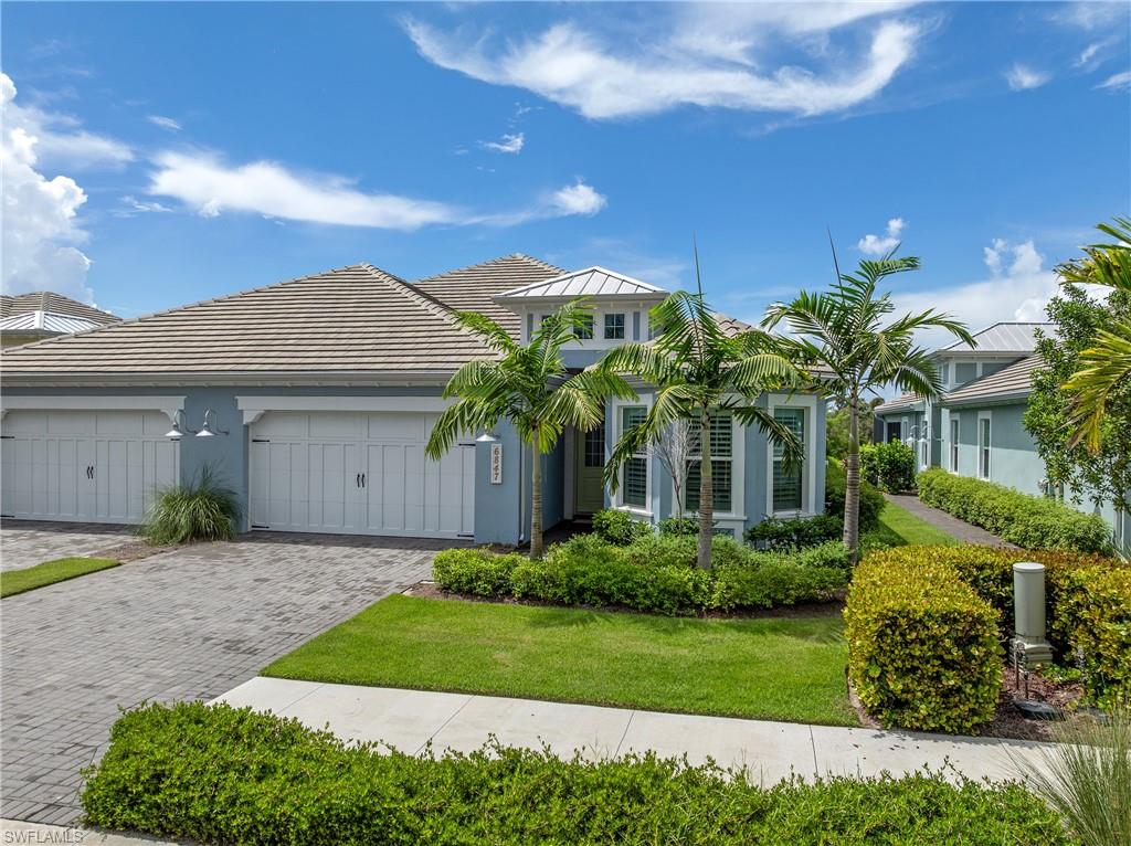 6847 Saona Court Naples, FL 34113 - Photo 3 of 47 a front view of house with yard and green space