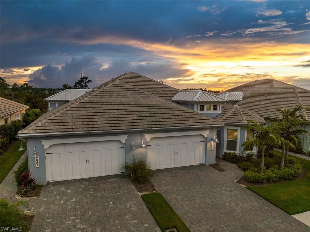 6847 Saona Court Naples, FL 34113 - Photo 31 of 47 a front view of a house with a yard