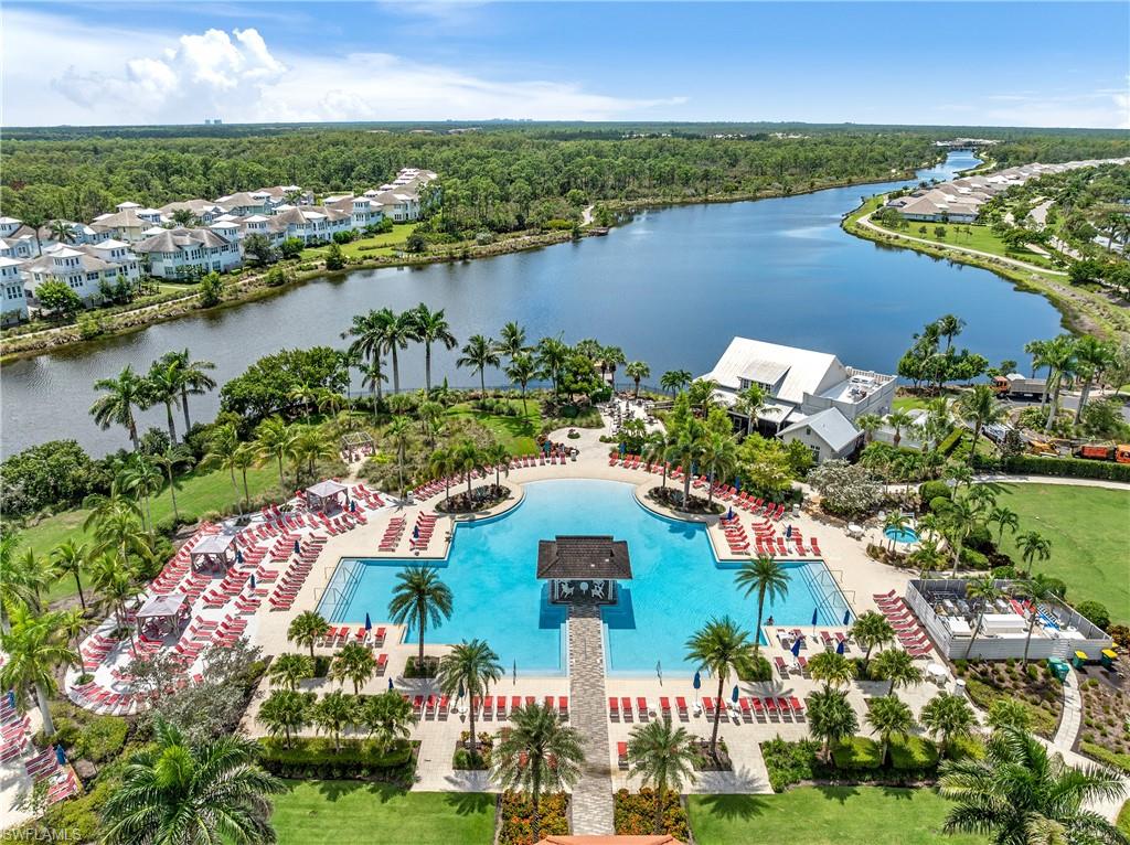 6847 Saona Court Naples, FL 34113 - Photo 32 of 47 an aerial view of residential houses with outdoor space and lake view