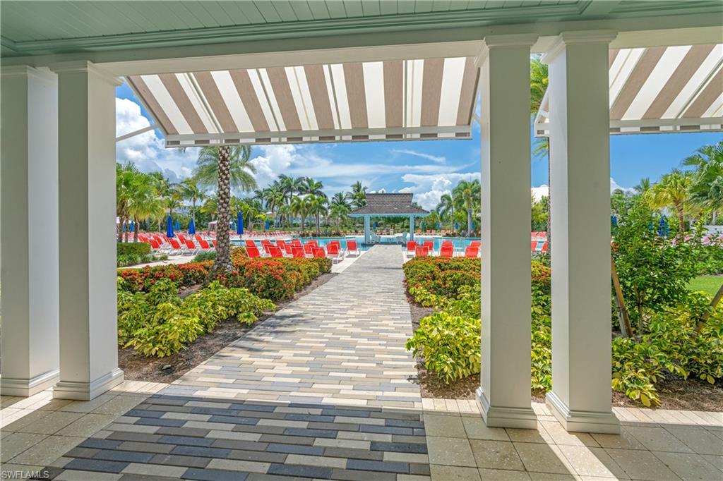 6847 Saona Court Naples, FL 34113 - Photo 35 of 47 a view of a garden with flowers
