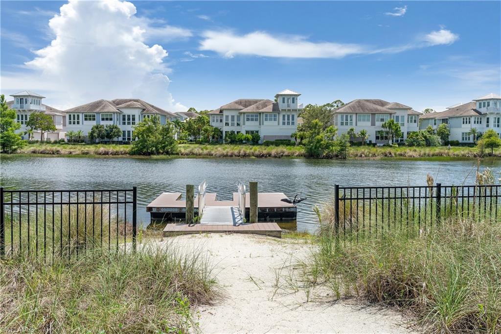 6847 Saona Court Naples, FL 34113 - Photo 38 of 47 a view of a lake with a city