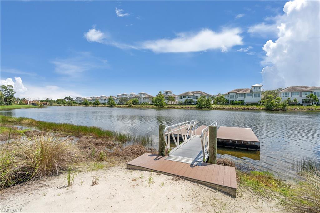6847 Saona Court Naples, FL 34113 - Photo 39 of 47 a view of a lake with a table and chairs