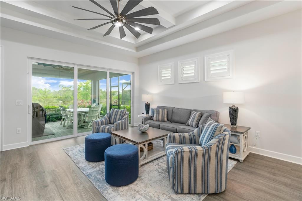 6847 Saona Court Naples, FL 34113 - Photo 8 of 47 a living room with furniture and a large window