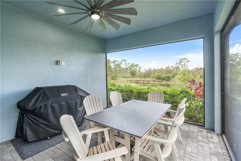 6847 Saona Court Naples, FL 34113 - Photo 9 of 47 a view of a dining room with furniture window and outside view