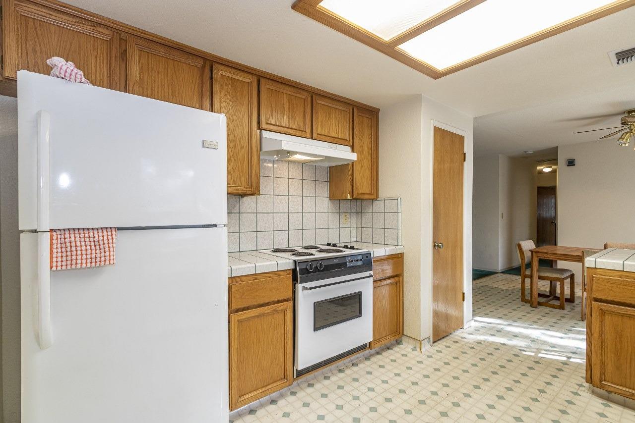 59634 Cascadel Drive North Fork, CA 93643 - Photo 13 of 52 a kitchen with a stove a refrigerator and cabinets