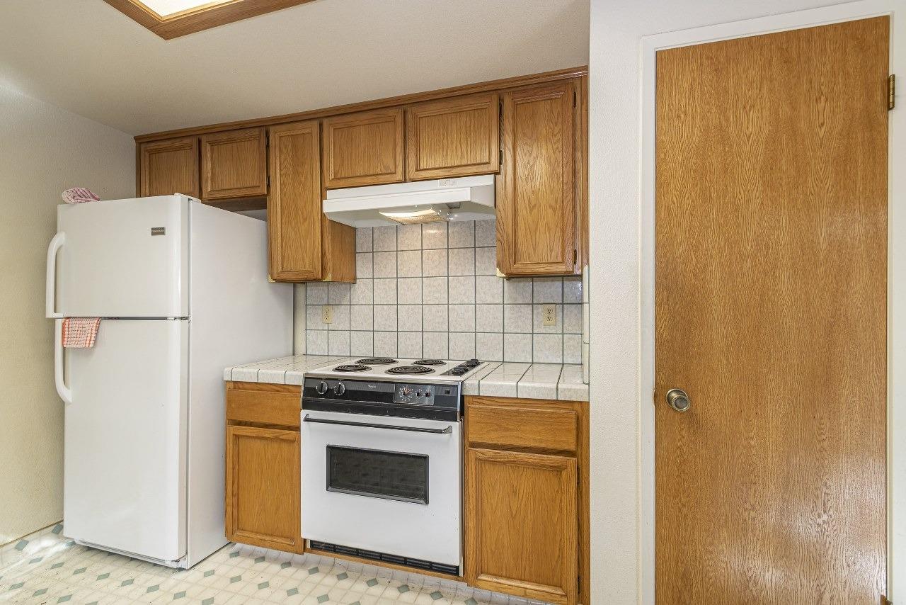 59634 Cascadel Drive North Fork, CA 93643 - Photo 15 of 52 a kitchen with a refrigerator stove and cabinets