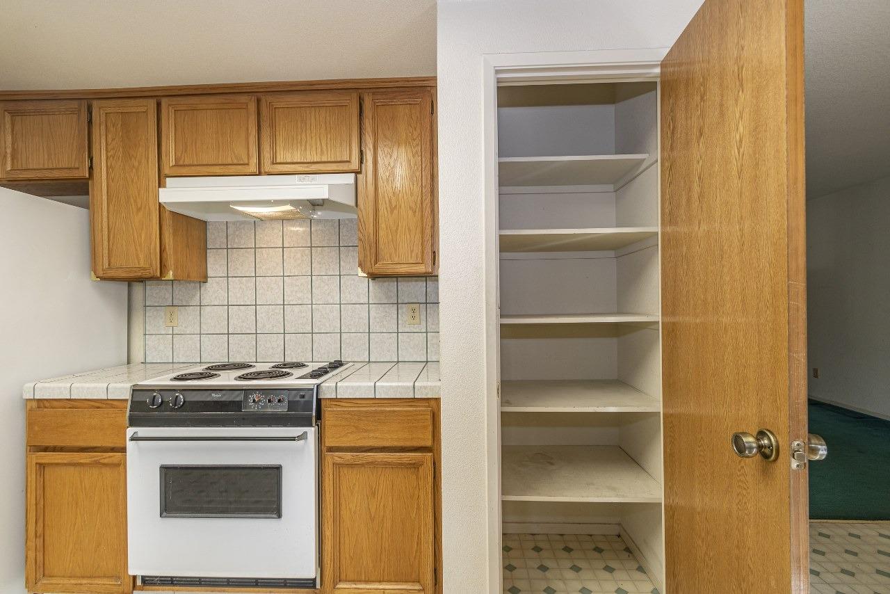 59634 Cascadel Drive North Fork, CA 93643 - Photo 16 of 52 a kitchen with a stove and a cabinet