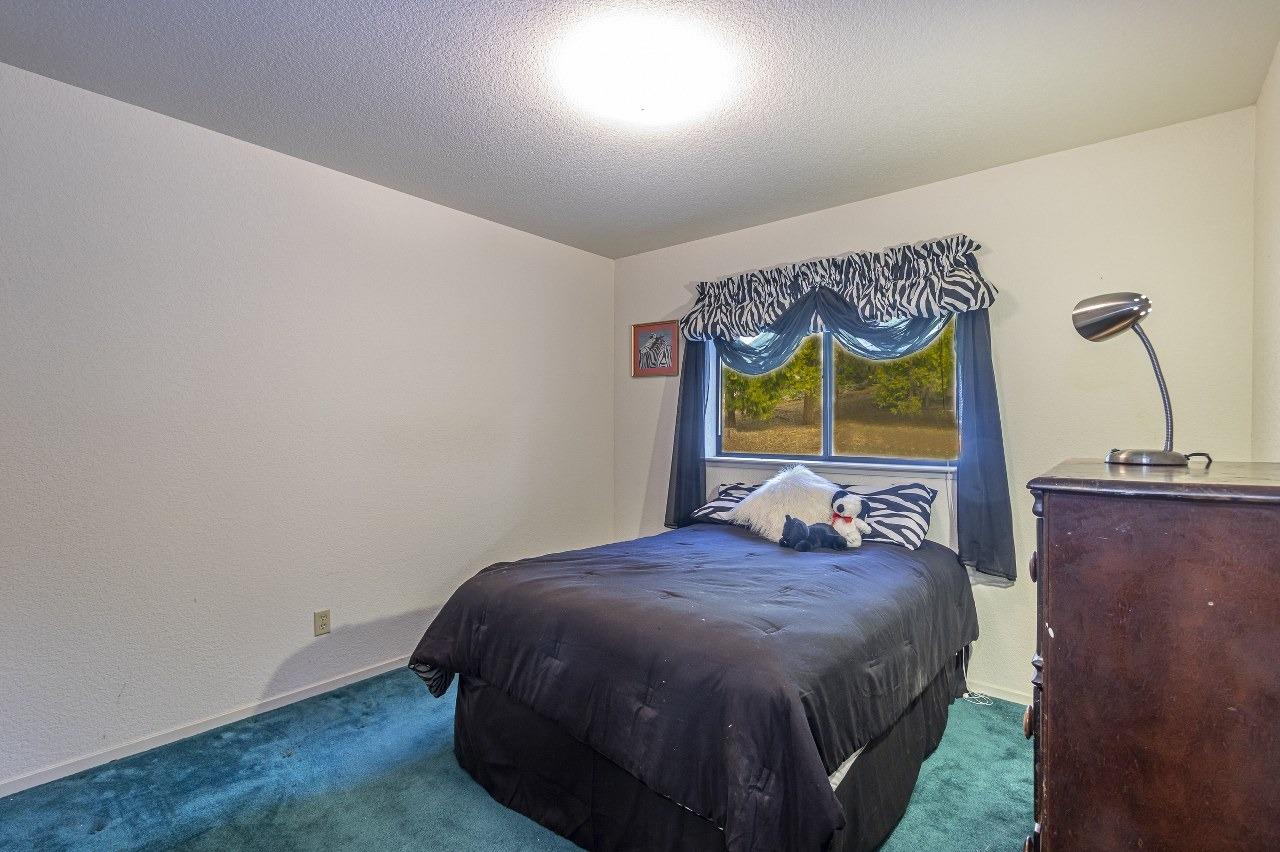 59634 Cascadel Drive North Fork, CA 93643 - Photo 18 of 52 a bed sitting in a bedroom next to a window