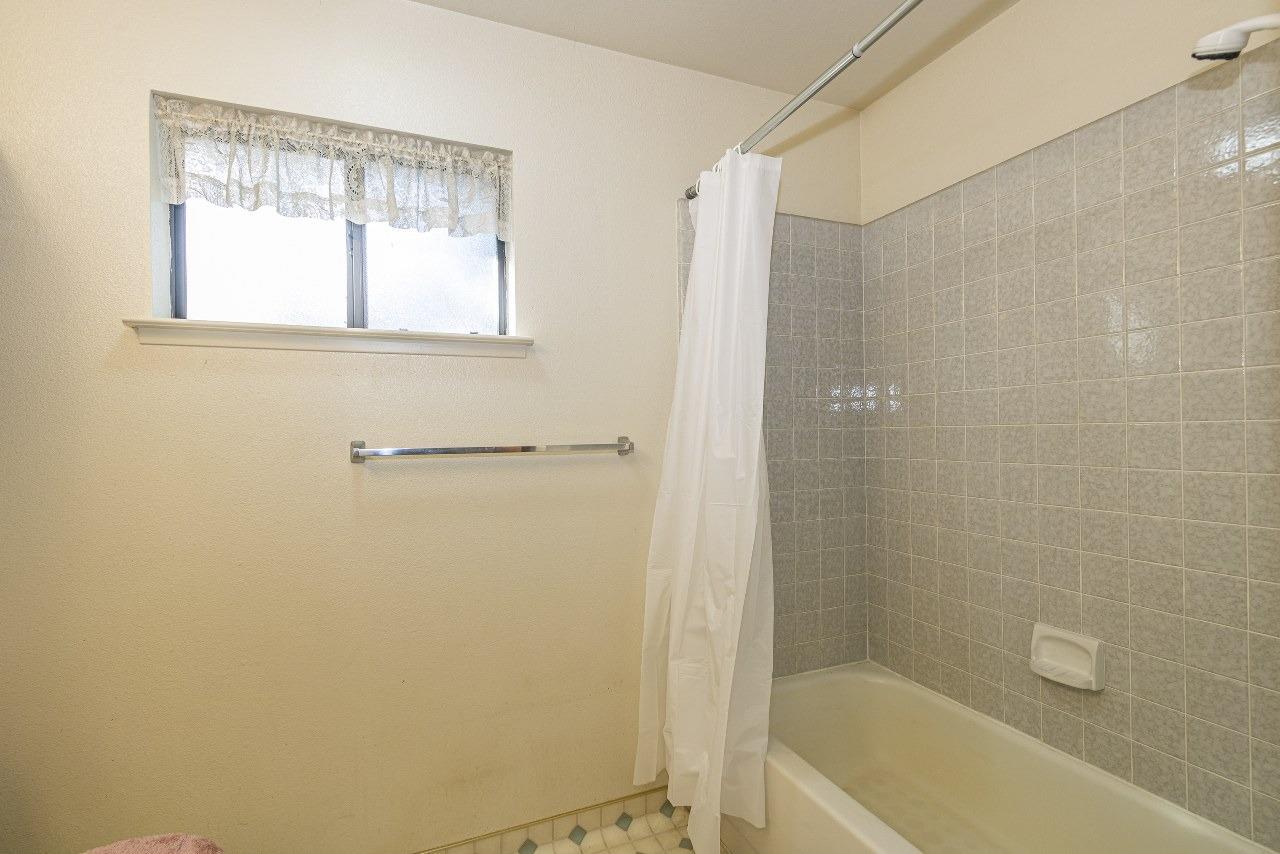 59634 Cascadel Drive North Fork, CA 93643 - Photo 21 of 52 a bathroom with a bathtub a shower and a window