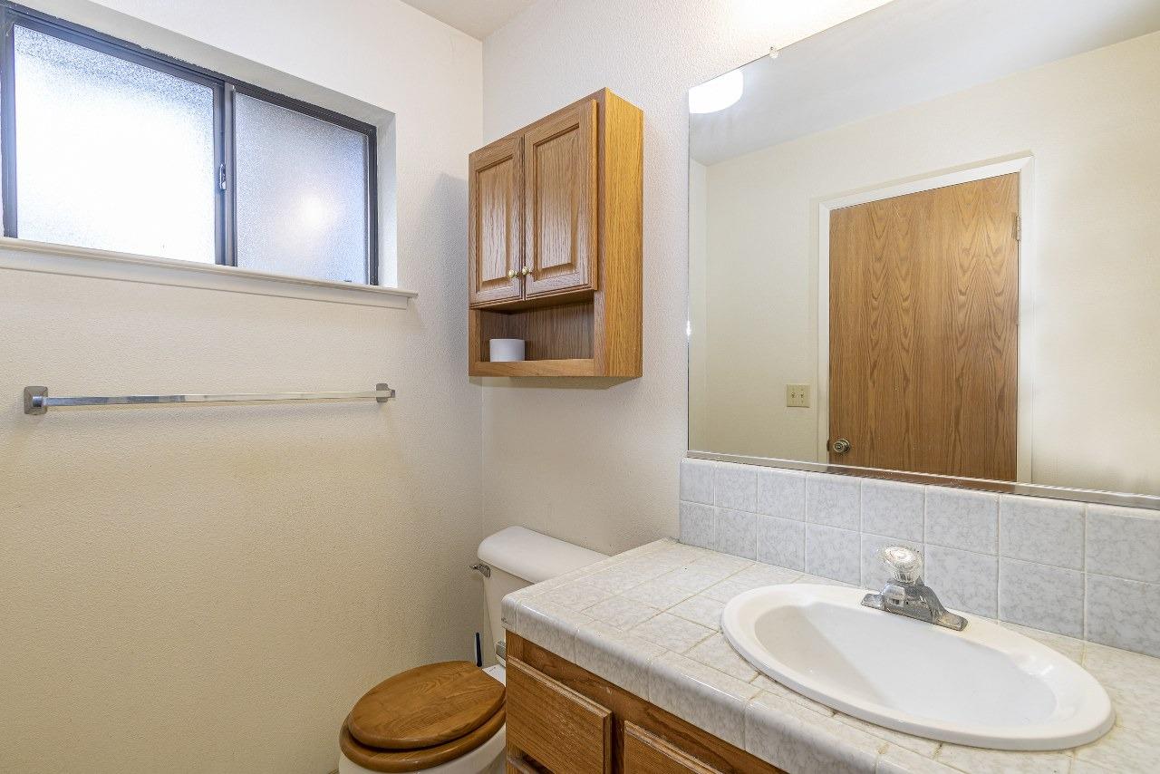 59634 Cascadel Drive North Fork, CA 93643 - Photo 29 of 52 a bathroom with a sink a toilet and mirror